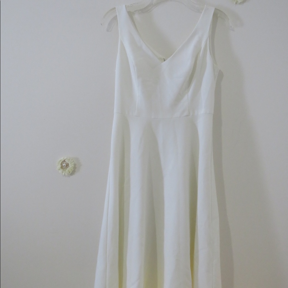 Knee length white dress.